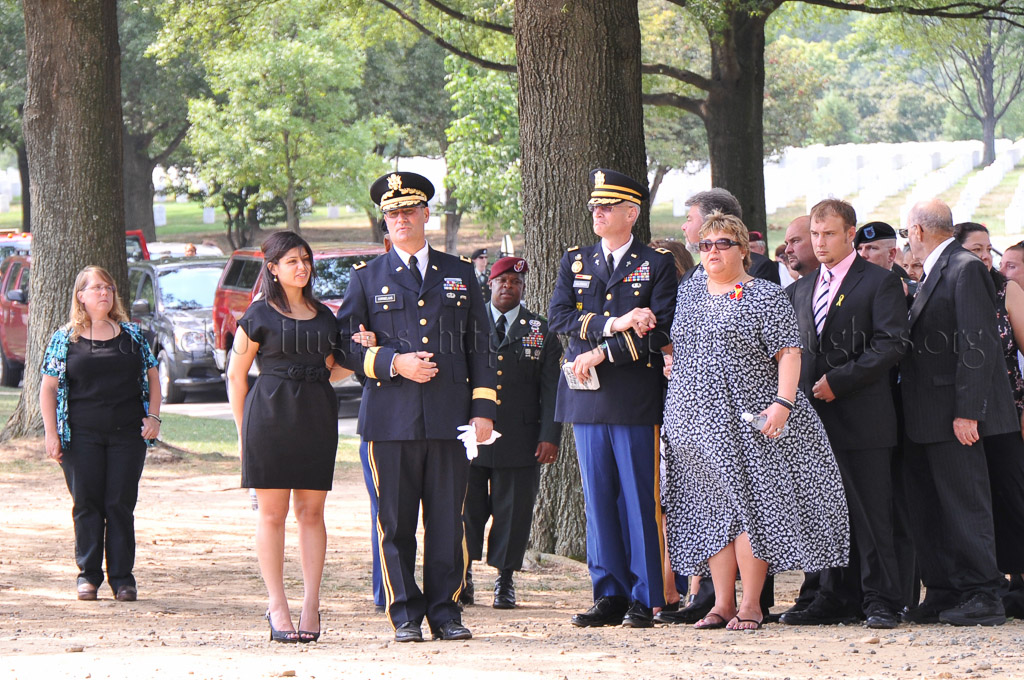 Army Officer and Chaplin escorting Lucas's Wife Trisha and his Mother Patti Elliott.