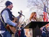 Country and Western singer Lindsay Lawler, right, and guitarist Chris Roberts sing "God Bless America" during the opening ceremony for the annual Wreaths Across America event at Arlington National Cemetery in Arlington, Va., Dec. 14, 2014. Thousands of volunteers helped place over 700,000 wreaths at the graves of fallen service members