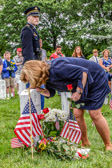 Karen Hernest Kelly, Mother of 1st Lt. Robert Michael Kelly USMC places a kiss on her sons headstone.  On November 9, 2010, Michael  was killed in action when he stepped on a landmine while leading a platoon of Marines on a patrol in Sangin, Afghanistan.