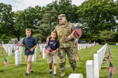 39th Chief Of Staff of the United States Army, General Mark A. Milley walks with the sons of Staff Sgt. Michael H. Simpson to their Father's gravesite in Section 60 of Arlington National Cemetery.