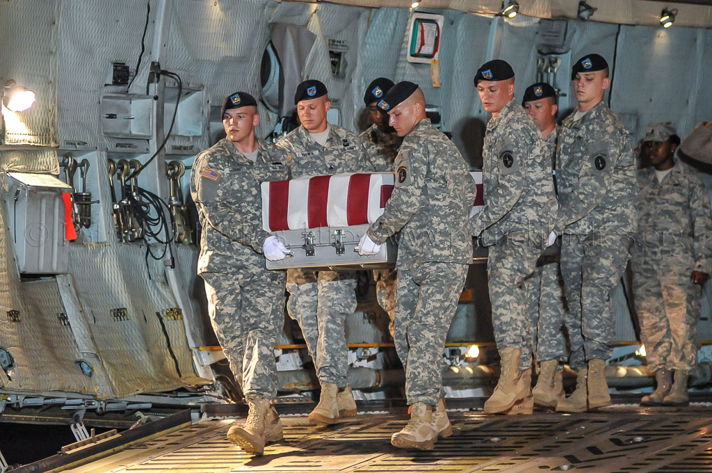 Army carry team carries the transfer case containing the remains of Pfc. Michael C. Olivieri, 26, Chicago, IL upon arrival at Dover Air Force Base, DE on June 8, 2011. The Department of Defense announced the death of Olivieri who was supporting Operation  New Dawn in Iraq.