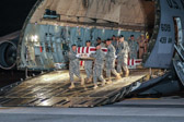 Army carry team carries the transfer case containing the remains of Spc. Emilio J. Campo Jr., 20, of Madelia, MN upon arrival at Dover Air Force Base, DE on June 8, 2011. The Department of Defense announced the death of Campo who was supporting Operation  New Dawn in Iraq.