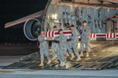 Army carry team carries the transfer case containing the remains of Spc. Michael B. Cook Jr., 27, of Middletown, OH upon arrival at Dover Air Force Base, DE on June 8, 2011. The Department of Defense announced the death of Cook who was supporting Operation  New Dawn in Iraq.