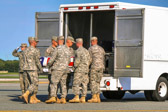 Army carry team moves the transfer case with the believed to be remains of Pfc. Jesse W. Dietrich into mortuary transfer vehicle.