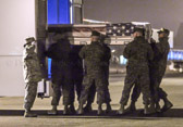 Marine carry team carries transfer case of Capt. Daniel B. Bartle to the mortuary transfer vehicle