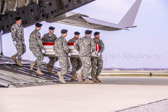 Army carry team moves the transfer case containing the believed to be remains of Army Staff Sgt. Christopher M. Ward to the mortuary transfer vehicle