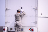 Air Force Senior Airman Tameca Burnett closes the door of a mortuary transport vehicle containing transfer cases containing the believed to be remains of Army Staff Sgt. Christopher M. Ward, and U.S. Army Corps of Engineers civilian Hyun K. Shin at Dover Air Force Base, DE. According to the Department of Defense, Shin of Hesperia, CA., and Ward of Oak Ridge, TN., both died while supporting Operation Enduring Freedom in Afghanistan.