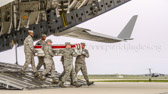 Air Force carry team carries transfer case of Capt. Brandon L. Cyr to the mortuary transfer vehicle