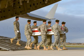 Carry team carries transfer case of Master Sgt. Joshua L. Wheeler from the C-17 to the mortuary transfer vehicle.