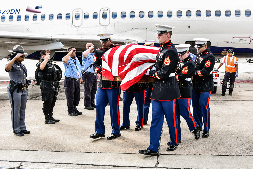 Marine carry team moves casket containing the remains of  2nd Lt George S. Bussa to awaiting hearse vehicle.