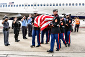 Marine carry team moves casket containing the remains of  2nd Lt George S. Bussa to awaiting hearse vehicle.