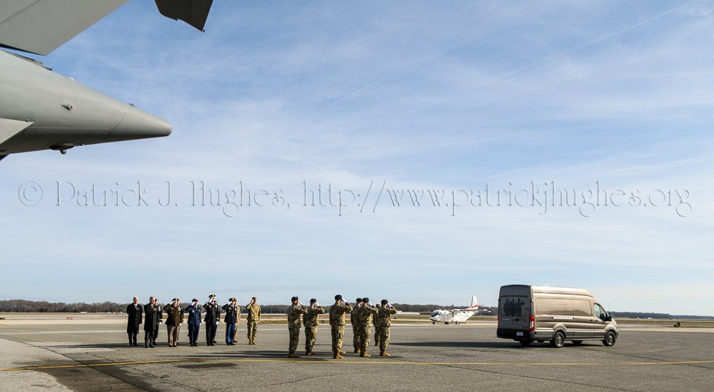 A final salute as the mortuary transfer vehicle leaves the tarmac for the base mortuary