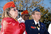 Linda Chamberlain and other Marine Corps League members look on during presentation of Colors.