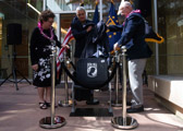 Natalie Rauch, daughter of unaccounted-for Col. Warren Anderson (left), Kelly McKeague, director of the Defense POW/MIA Accounting Agency (DPAA) (center), and U.S. Navy retired Capt. James Hickerson, former prisoner of war (right), unveil a chair as part of a ceremony at DPAA’s facility on Joint Base Pearl Harbor-Hickam, Hawaii, Feb. 7, 2020. The new stadium-style chair, which will be permanently secured in DPAA’s facility, pays tribute to the more than 81,000 unaccounted for American service members from our nation’s past conflicts. DPAA’s mission is to provide the fullest possible accounting of our missing personnel to their families and the nation. (U.S. Air Force photo by Staff Sgt. Leah Ferrante)