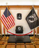 A Chair of Honor is very simple yet POWERFUL, it's a single black chair with the POW/MIA Logo on it which is then flanked by the American Flag and the POW/MIA Flag. Along with the Chair is a plaque that states since WWII over 81 thousand servicemen remain unaccounted for. This chair is in their honor until they come home. They will not be FORGOTTEN.