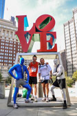 Runners Lloyd ‘Krazy’ Fenner and Charles "Chunks" Padilla at the Philadelphia landmark LOVE statue along with the blue and gray man team.