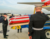 Marine Escort SSGT. Samuel Kennard comes to attention and renders his salute