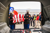 Marine Body Bearers place the casket containing the remains of PFC Raymond Warren into the hearse.