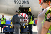 Hand Salute is call, Mike Dunn BWI Security salutes as the casket bearing the remains of 1st Lt. Justin G. Mills is lowered down the ramp.