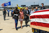 Marine Escort walks niece Janet Cook and her friend Steve up to casket containing the remains of her uncle First Lieutenant Justin G. Mills