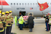 Hand Salute is called, Mike Dunn BWI Security salutes as the casket bearing the remains of Pvt. William E. Rambo is lowered down the ramp