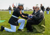 Sergeant Major Jesse Dorsey presents flag saying "On behalf of the President of the United States, the Commandant of the Marine Corps, and a grateful nation, please accept this flag as a symbol of our appreciation for your loved one's service to Country and Corps."