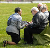 Fern Sumpter Winbush the Principal Deputy Director for the Defense POW/MIA Accounting Agency (DPAA) makes a presentation to the family.