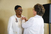 Pinning Ceremony, unfortunately because of covid restrictions PNP Mona Gunn did get to host a convention.  Outgoing President Cindy Tatum pins PNP Mona Gunn.