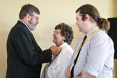 Andy Tatum pins his wife Cindy as their proud son Nic looks on.